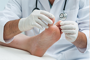 A doctor checking a patient’s toenails | Foot and Ankle Specialist