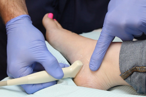 A podiatrist checking a patient’s foot | Doctor of Podiatric Medicine